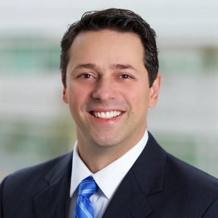 A person in a suit and tie AI-generated content may be incorrect.